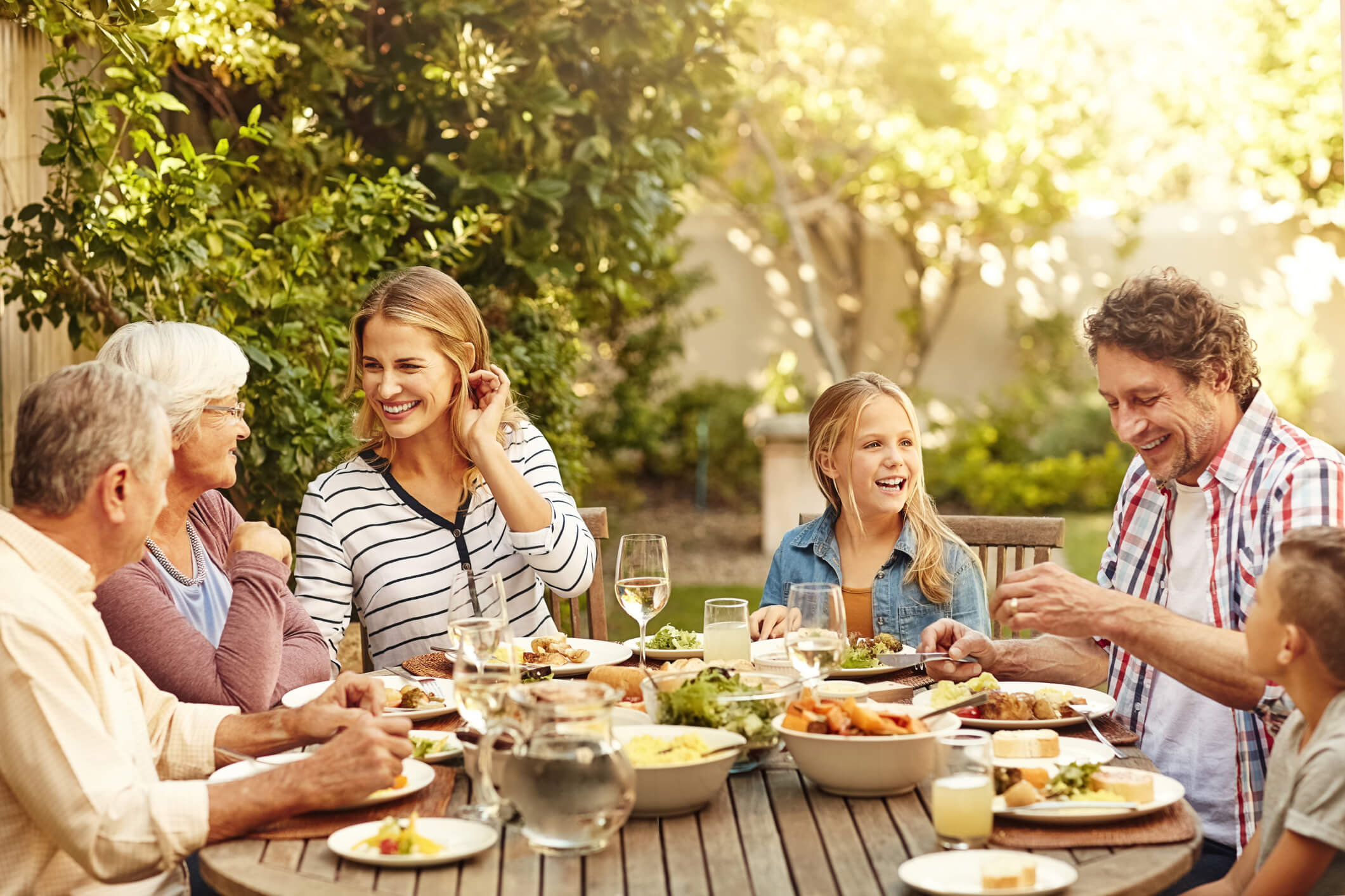 Family gathered together outside for a meal